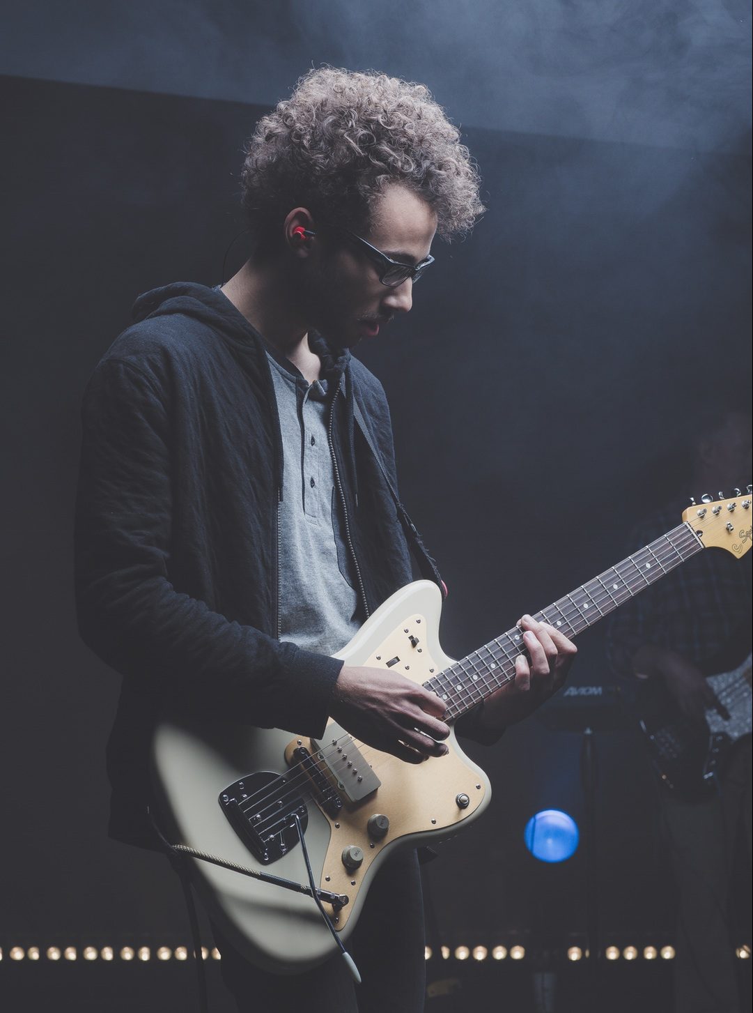 Man playing a guitar on stage