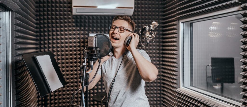 Man singing in a recording studio